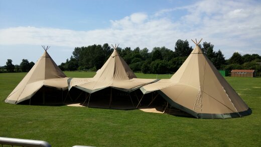Photo of the field with teepees set up