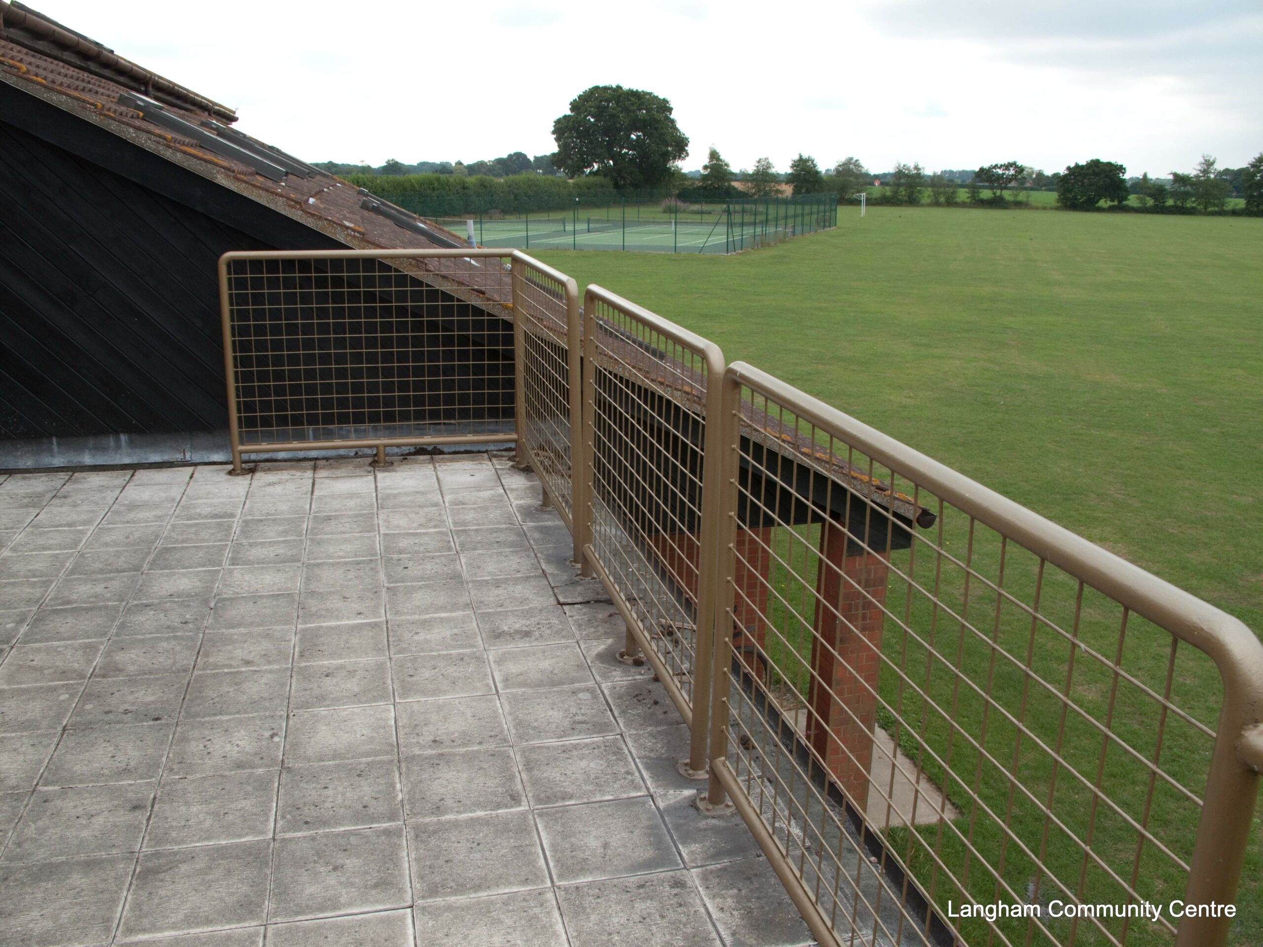Photo of the Committee Room's balcony, overlooking the tennis courts and the field